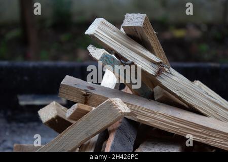 Morceaux de bois empilés dans un grill brûlant dans un feu d'orange.Préparation du gril la nuit.Heure du dîner. Banque D'Images