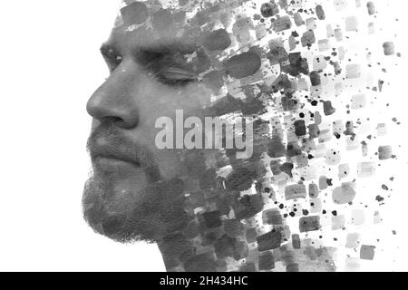Peinture.Un portrait noir et blanc d'un jeune homme beau combiné à des éclaboussures d'encre noire. Banque D'Images