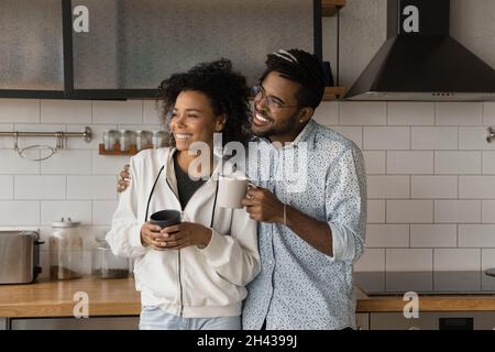 Heureux aimant jeune couple afro-américain rêvant de jour dans la cuisine. Banque D'Images
