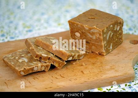 Sorbet aux arachides et au caramel sur une planche en bois.Gros plan de la torrone de l'écrou.Dessert au caramel et aux noix.Sorbet maison à base de crème, sucre et rôti Banque D'Images