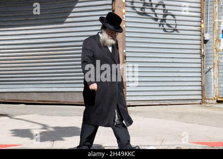 Un juif orthodoxe marche tout en pensant profondément.Sur Lee Avenue à Williamsburg, Brooklyn, New York. Banque D'Images