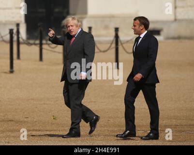 (À gauche) le Premier ministre Boris Johnson et le président français Emmanuel Macron marchent ensemble au Horse Guards Parade pour observer les flèches rouges et leur équivalent français, la Patrouille de France, survolant Londres pour marquer le 80e anniversaire de la diffusion en temps de guerre du leader français de la résistance Charles de Gaullé.Date de la photo: Jeudi 18 juin 2020. Banque D'Images