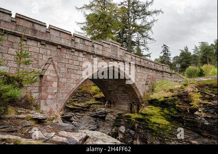 Le pont en pierre qui traverse les rapides de la rivière Dee dans les montagnes Cairngorms d'Écosse Banque D'Images