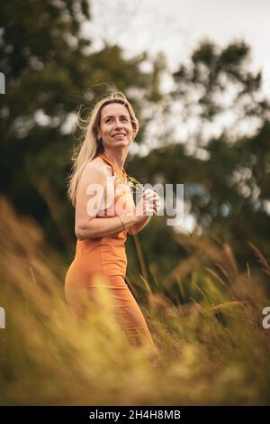 Portrait d'une femme d'âge moyen détendue à l'extérieur, à l'air heureux, en appréciant la vie Banque D'Images