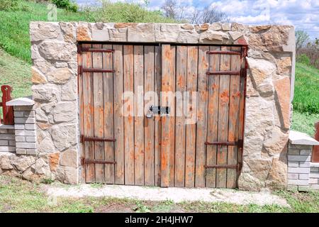 Porte en bois fermée de cave rustique.Entrée de la cave à vin, vue extérieure Banque D'Images