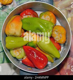 Gros plan des étapes de mise farcie de riz et de carottes poivrons dans une casserole en aluminium. Banque D'Images