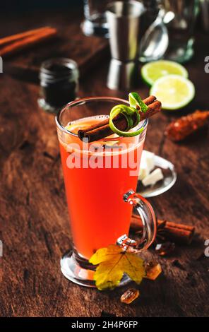 Rhum au beurre chaud, cocktail chaud d'hiver avec jus de pomme, rhum foncé, miel, cannelle en verre sur fond de bois Banque D'Images