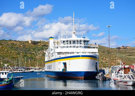 Bateaux de pêche et le ferry Gozo amarrés dans le port, Mgarr, Gozo, Malte, Europe. Banque D'Images