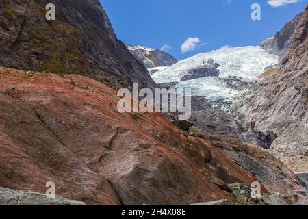 Rocher rouge sur fond de glacier.Glacier Franz Joseph.Île du Sud, Nouvelle-Zélande Banque D'Images