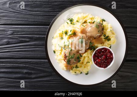 Boulettes de viande Lihapullat avec purée de pommes de terre et confiture de lingonberry dans une assiette sur la table.Vue horizontale du dessus Banque D'Images
