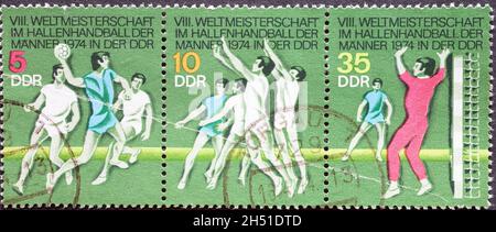 ALLEMAGNE, DDR - VERS 1974 : timbre-poste de l'Allemagne, RDA montrant le championnat du monde de handball intérieur 1974 pour hommes, projection de but, défense, craie Banque D'Images