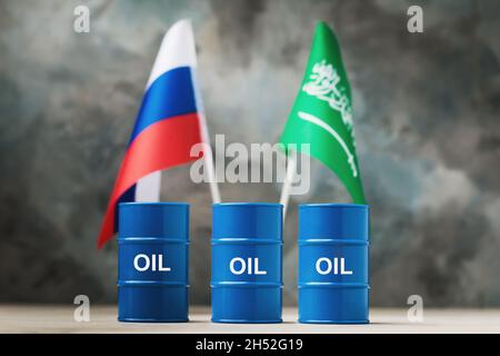 Trois barils de pétrole dans le contexte des drapeaux de la Russie et de l'Arabie saoudite, un concept sur le thème de la production et de la réglementation des prix dans Banque D'Images