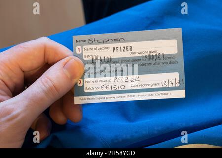 Homme de 40 ans tenant une carte de confirmation de vaccin après avoir reçu sa deuxième vaccination contre le coronavirus Covid-19 en Angleterre, 2021 Banque D'Images