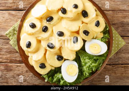 Papa a la Huancaina est un apéritif péruvien classique de pommes de terre étouffées d'un délicieux fromage et d'une sauce au Chili dans l'assiette sur la table. Banque D'Images