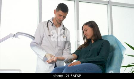 Examen médical préventif planifié d'une jeune femme à la clinique.Le médecin mesure la pression artérielle du patient au bureau Banque D'Images