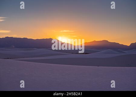 Le soleil se trouve derrière les montagnes de San Andres et se trouve dans le parc national, Dans une teinte pourpre au-dessus des dunes de sable blanc Banque D'Images