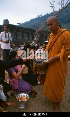 Laos: Des moines bouddhistes exécutant leur quotidien tôt le matin almsround à Vat Phou (Wat Phu), un sanctuaire de temple hindou khmer ruiné (maintenant bouddhiste), province de Champasak, sud du Laos.Wat Phu faisait partie de l'empire khmer, centré sur Angkor au sud-ouest, au moins dès le règne de Yashovarman I au début du Xe siècle.Plus tard, les bâtiments d'origine ont été remplacés, mais certains des blocs de pierre d'origine ont été réutilisés.Le temple tel qu'il est aujourd'hui a été construit principalement pendant les périodes de Koh Ker et de Baphuon du XIe siècle. Banque D'Images