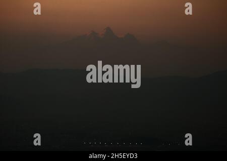 Bhaktapur, Bagmati, Népal.9 novembre 2021.Mont Manaslu (8,163 mètres), la huitième plus haute montagne du monde, est photographiée sur fond de lumières de passage de l'aéroport international de Tribhuwan, vu de Ranikot du district de Bhaktapur le 9 novembre 2021.Credit: Amit Machamasi/ZUMA Wire/Alay Live News Banque D'Images