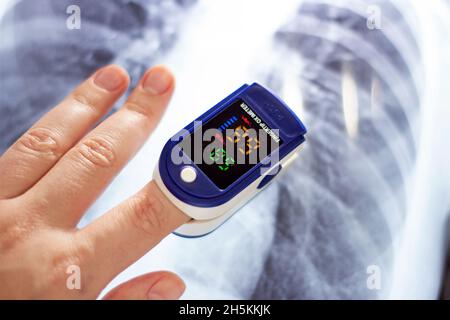 Femme main avec un oxymètre de pouls médical fingertip pour le contrôle de la saturation en oxygène pendant la défacilité du virus Covid.Mesure de la SpO2 et de la fréquence cardiaque Banque D'Images