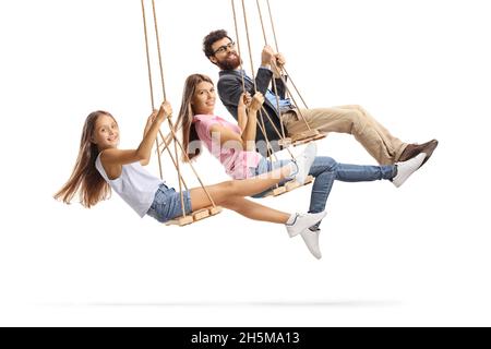 Une famille heureuse se balançant sur des balançoires en bois isolées sur fond blanc Banque D'Images