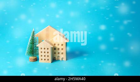 Maisons en bois et arbre de Noël sur fond bleu.Préparation pour les vacances.Fête des vacances d'hiver.Joyeux noël et Bonne Année.C Banque D'Images