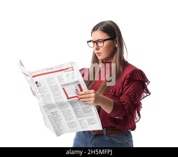 Belle femme en lunettes lisant le journal sur fond blanc Banque D'Images