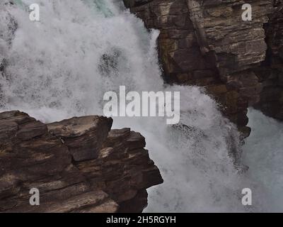 Vue en gros plan des célèbres chutes Athabasca dans le parc national Jasper, Alberta Canada dans les montagnes Rocheuses avec de l'eau qui coule entre des roches superposées. Banque D'Images