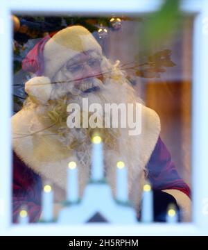 11 novembre 2021, Brandebourg, Fürstenberg/Havel/OT Himmelpfort: Le Père Noël se tient derrière des fenêtres fermées après son arrivée au bureau de poste de Noël.Le Père Noël prévoit d'être dans son bureau de poste de Noël du vendredi au dimanche chaque week-end jusqu'à la veille de Noël.Pendant ce temps, il peut être vu par la fenêtre de réponse au courrier.Cependant, en raison de la menace d'infection continue de Corona, son bureau décoré de Noël ne sera pas ouvert au public pour les visiteurs cette année.Photo: Soeren Stache/dpa Banque D'Images