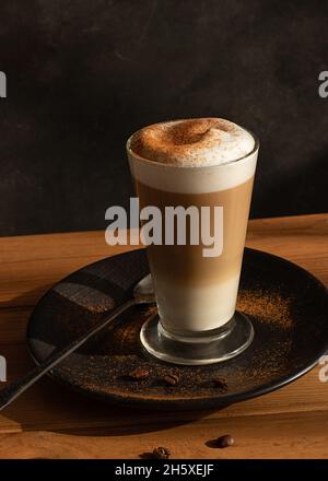 Un verre de café latte frais, chaud et aromatique est servi sur une table Banque D'Images
