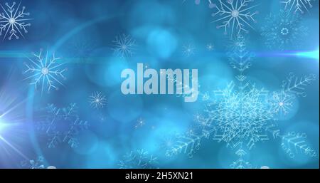 Image de flocons de neige de noël tombant sur fond bleu bokeh Banque D'Images