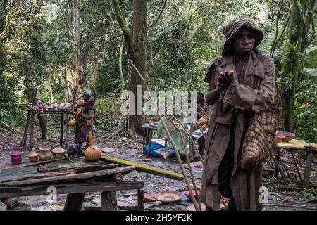 Septembre 2017.Les Pygmées Batwa ont été expulsées de leurs terres d'origine dans la forêt au début des années 1990, lorsque les parcs nationaux ont été établis, les laissant sans terre et pauvres dans une société qui les considérait comme une classe inférieure.Aujourd'hui, certains d'entre eux essaient de faire la rencontre des extrémités en organisant des promenades sur les sentiers; des visites culturelles qui incluent des exemples de l'endroit et de la façon dont ils utilisent pour vivre dans la forêt, ainsi que du chant, de la danse et de l'artisanat pour la vente.Buhoma, Ouganda. Banque D'Images