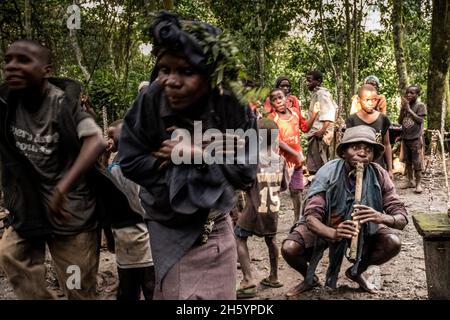 Septembre 2017.Les Pygmées Batwa ont été expulsées de leurs terres d'origine dans la forêt au début des années 1990, lorsque les parcs nationaux ont été établis, les laissant sans terre et pauvres dans une société qui les considérait comme une classe inférieure.Aujourd'hui, certains d'entre eux essaient de faire la rencontre des extrémités en organisant des promenades sur les sentiers; des visites culturelles qui incluent des exemples de l'endroit et de la façon dont ils utilisent pour vivre dans la forêt, ainsi que du chant, de la danse et de l'artisanat pour la vente.Buhoma, Ouganda. Banque D'Images