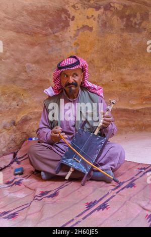 Petra, Jordanie - 23 octobre 2021: Portrait d'un homme bédouin local joue un Rebab, dans l'ancienne ville nabatéenne de Petra, au sud de la Jordanie Banque D'Images