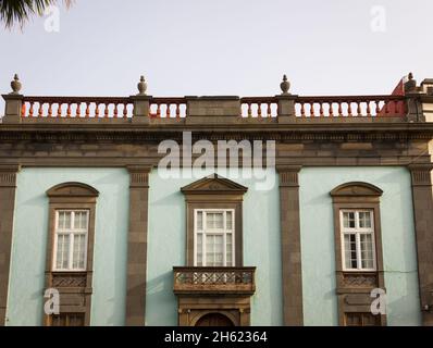 Maison classique aux couleurs pastel vertes dans le centre-ville de Gran Canaria, en Espagne.Lumière du coucher de soleil touchant doucement façade du bâtiment résidentiel à Vegueta, Las Pa Banque D'Images