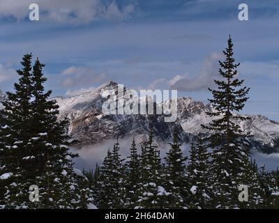 Vue imprenable sur la montagne sauvage de Franchere Peak avec une face rocheuse enneigée au-dessus de la vallée de la rivière Astoria, couverte de nuages, dans le parc national Jasper, Canada. Banque D'Images