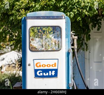 Ancienne pompe à gaz du Golfe avec des usines qui y poussent. Banque D'Images