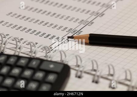Rapport financier, crayon et papier avec des chiffres sur la table du bureau.Une feuille de papier pleine de données d'entreprise.Numéro de compte sur le papier de données. Banque D'Images