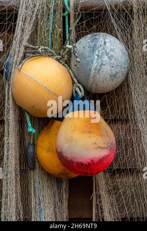 flotteurs de pêche colorés et filets de pêche accrochés au sec sur le côté d'une ancienne huttes de plage en bois à la crique de steephill près de ventnor sur l'île de wight. Banque D'Images