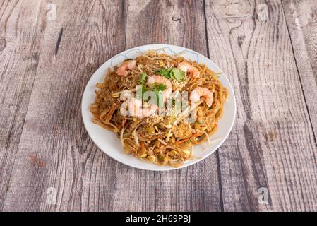 Tampon thaï, nouilles de riz, sauce de poisson, pâte de tamarin, poivron rouge,pousses de haricots, crevettes, poulet aux arachides et à la coriandre hachées, coin de citron, banane Banque D'Images