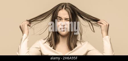 Femme frustrée ayant de mauvais cheveux. Femme ayant un mauvais cheveux, ses cheveux sont désordonnés et emmêlés. Cheveux salissants. Brunette femme aux poils disgracieux. Fille ayant Banque D'Images