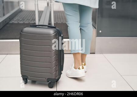 Voyageur aérien utilisant le système de dépôt de bagages en libre-service Banque D'Images