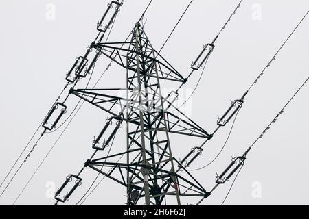 Gros plan de lignes électriques aériennes de 220 kV à très haute tension sur grand pylône, tour.Longue distance, transmission de puissance très élevée.Ciel nuageux, espace de copie Banque D'Images