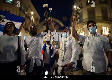 Malaga, Espagne.15 novembre 2021.Des manifestants ont vu des œillets se manifester en faveur du peuple cubain dans la rue marques de Larios.des dizaines de personnes ont pris la rue en solidarité avec la « Marche civique pour le changement », en réponse à la dictature du gouvernement cubain.Crédit : SOPA Images Limited/Alamy Live News Banque D'Images