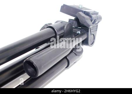 Trépied noir sur fond blanc avec mise au point sélective Banque D'Images