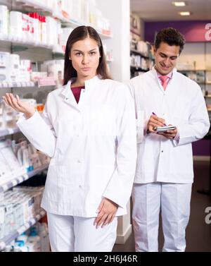 Portrait de deux pharmaciens amicaux travaillant Banque D'Images