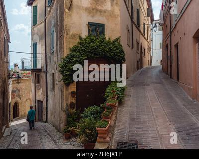 Une personne marchant dans les rues centrales de la vieille ville de Trevi à une fourchette, Trevi, Ombrie, Italie, Europe Banque D'Images