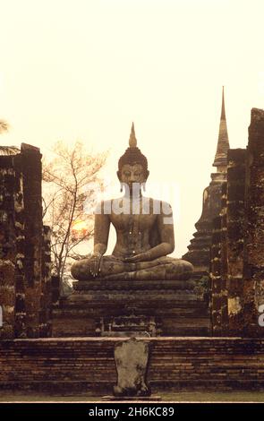 Coucher de soleil sur un Bouddha au temple Phra si Mahathe, Parc historique de Sukhothai, Thaïlande Banque D'Images