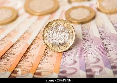 Argent: Une et deux pièces de livre se sont assis sur des billets de dix et vingt livres.£1 £2 £10 £20 Livre Sterling currency.Gros plan, arrière-plan. Banque D'Images
