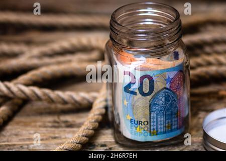 Gros plan des billets de banque dans un pot en verre avec texte voiture neuve.Concept d'investissement et de conservation de l'argent Banque D'Images