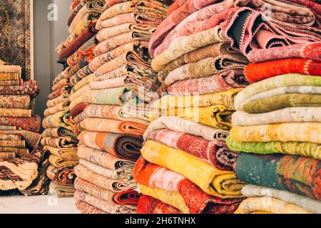 Pile de tapis et tapis orientaux traditionnels comme arrière-plan avec l'espace de copie.Tapis décoratifs multicolores au magasin de tapis.Populaire touristique Banque D'Images